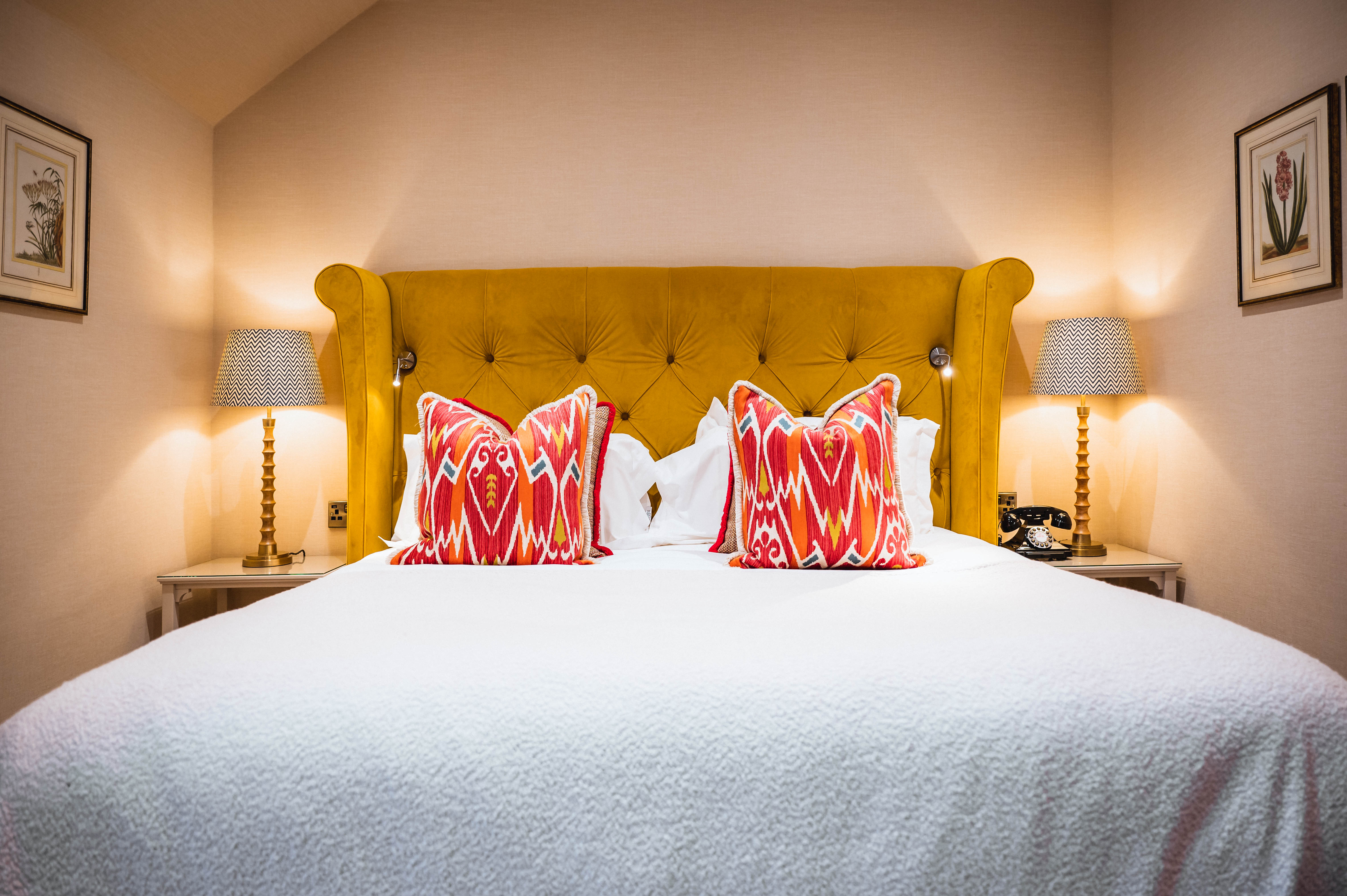 Luxurious bedroom with soft lighting and decorative cushions, highlighting the elegance of The Torridon.