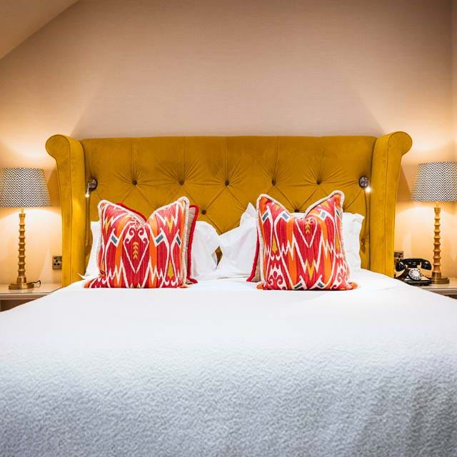 Luxurious bedroom with soft lighting and decorative cushions, highlighting the elegance of The Torridon.